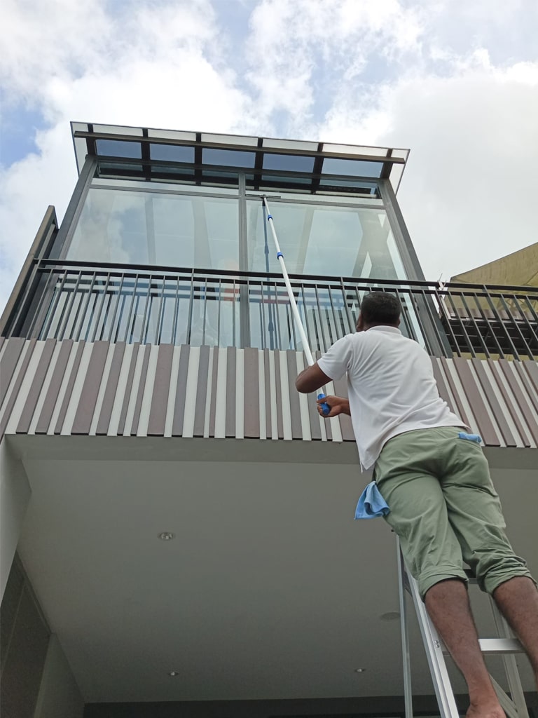 a person window cleaning the house