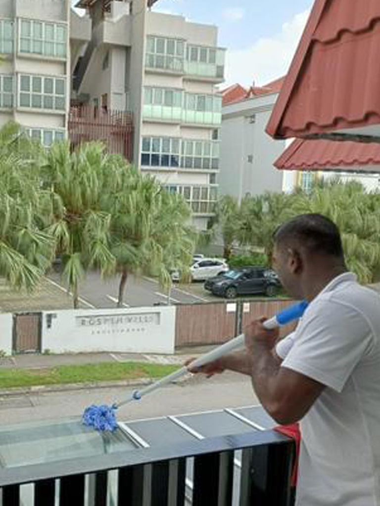 the guy is cleaning the overhang roof