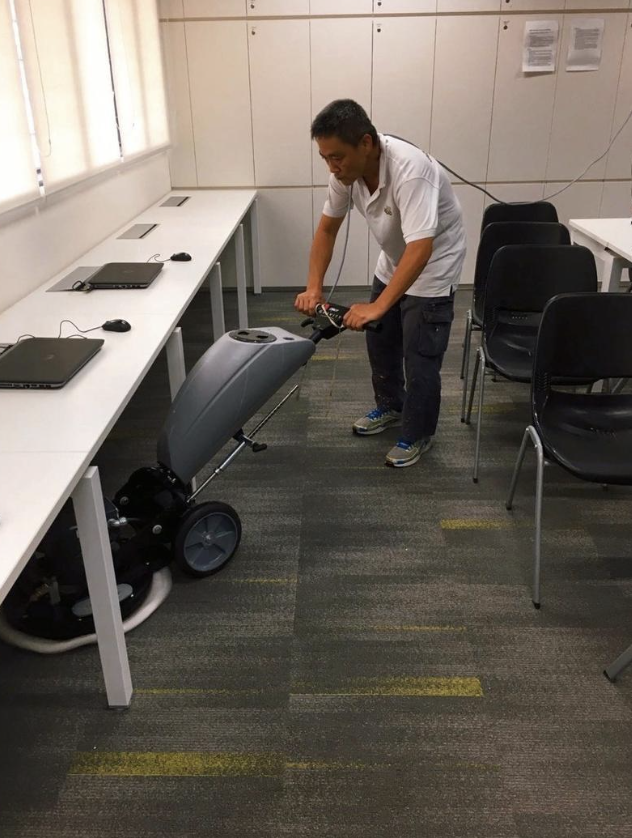 Man Cleaning The Floor In Office