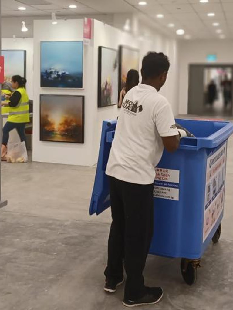 person moving recycling bin