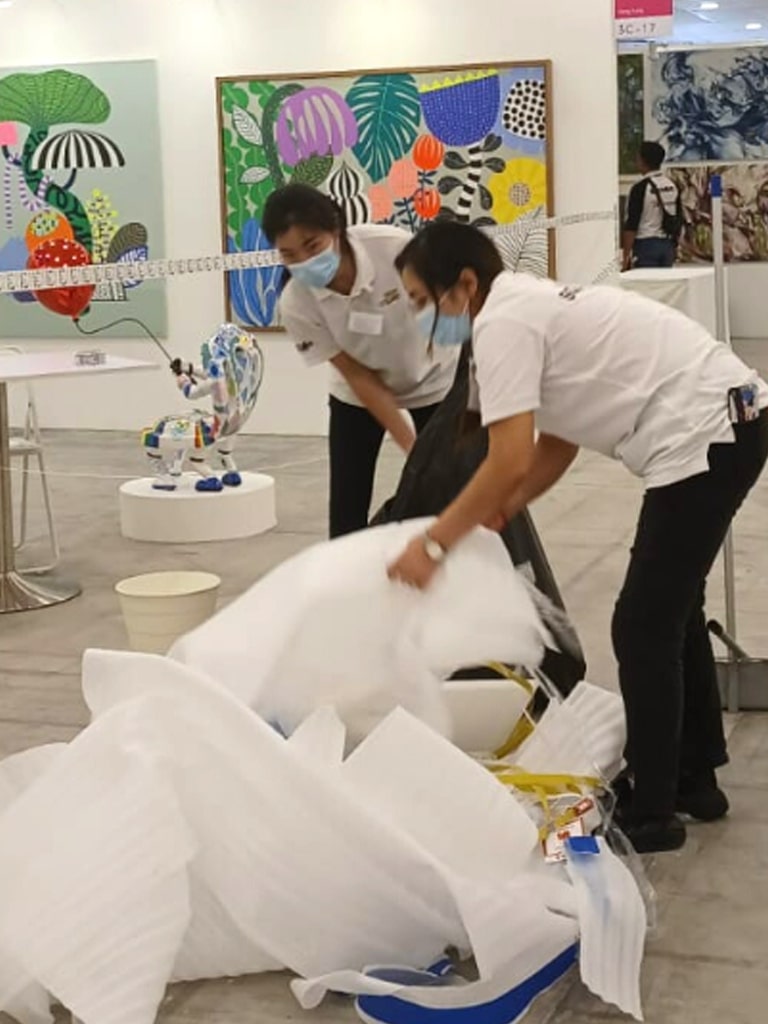 two people throwing trash from event